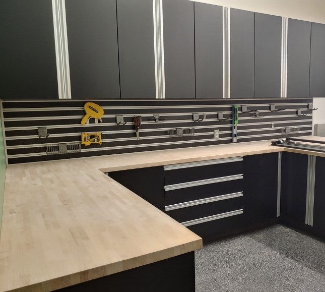 Black cabinets with a wood counter top